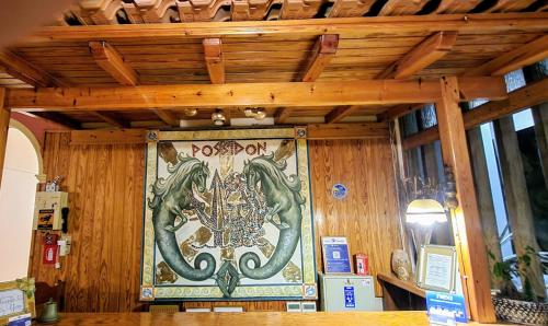 a wall with a painting of a dragon on it at Possidon in Agia Marina Aegina