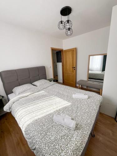 a bedroom with a large bed with two pillows on it at Roza Cozy Apartment in Vinkovci