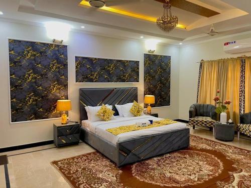 a bedroom with a king sized bed and a living room at Umda Safari in Islamabad