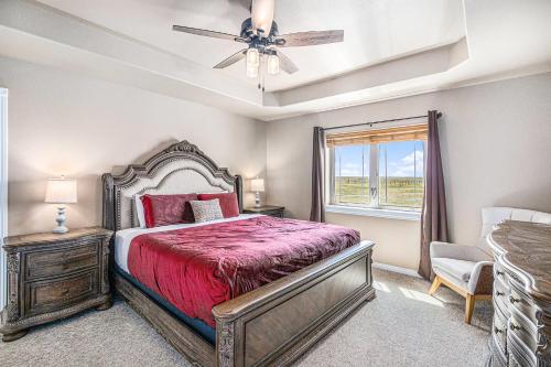 a bedroom with a bed and a ceiling fan at Ranch Retreat W Hot Tub & Patio in Cheyenne