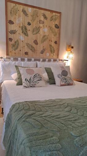 a bedroom with a large white bed with pillows at Varanda de Coimbra in Penacova