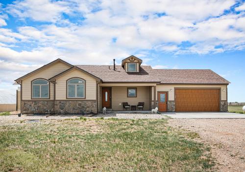 a house with a dog in front of it at Ranch Retreat W Hot Tub & Patio in Cheyenne