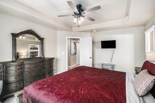 a bedroom with a bed and a dresser and a mirror at Ranch Retreat W Hot Tub & Patio in Cheyenne