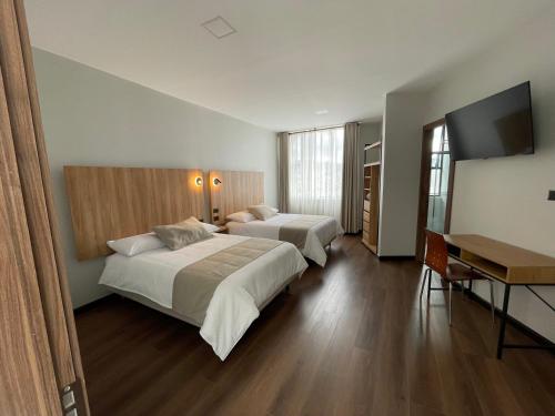 Postel nebo postele na pokoji v ubytování Universitario Hotel