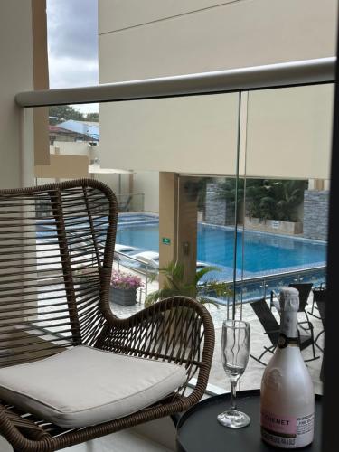 a wicker chair sitting on a table with a wine glass at Hotel y Cabañas Covemar in Coveñas