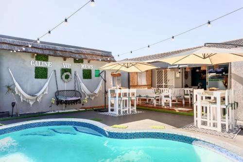 a house with a swimming pool and a patio at Caline VIP Luxury Jacuzzi &, Swimming Pool MEWS in Cape Town