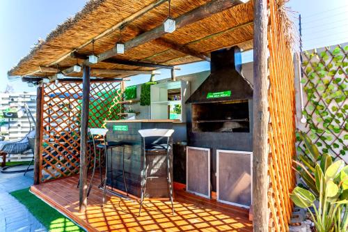an outdoor kitchen with a grill on a deck at Caline VIP Luxury Jacuzzi &, Swimming Pool MEWS in Cape Town