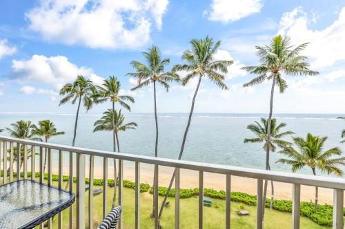 a view of the beach from the balcony of a resort at Amazing 7th floor Beachfront Condo in Hauula