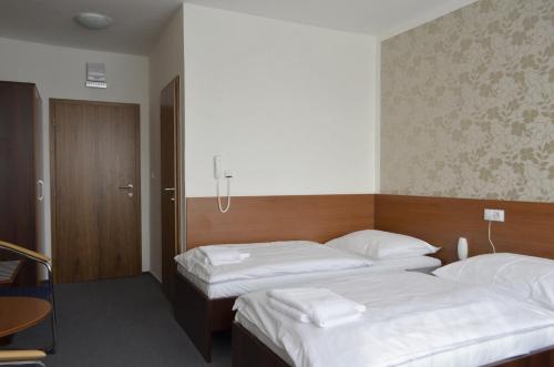Postel nebo postele na pokoji v ubytování Hotel Arkáda