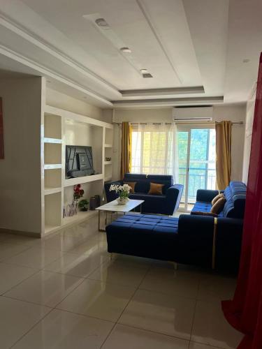a living room with a blue couch and a table at Mo Residence SD City in Dakar