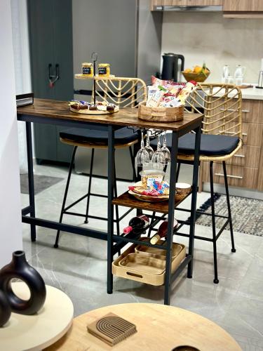 a table in a kitchen with two stools at Happy Stay in Larisa
