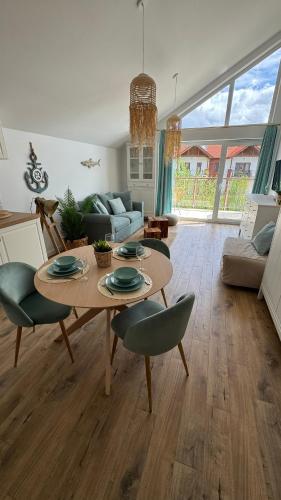a living room with a table and chairs at Rajski Zakątek in Żarnowska