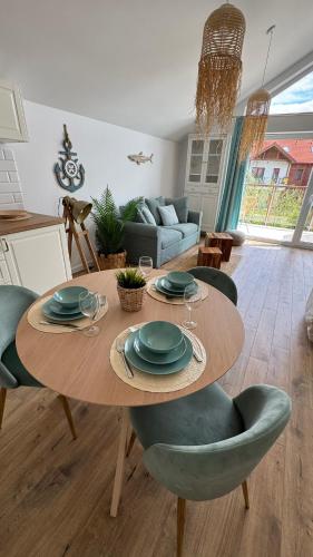 a table and chairs in a living room at Rajski Zakątek in Żarnowska
