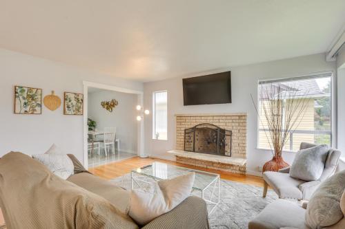 a living room with a couch and a fireplace at 7 Mi to Dtwn Pet-Friendly Abode in Seattle! in Seattle