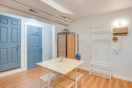 a room with a table and a blue door at 7 Mi to Dtwn Pet-Friendly Abode in Seattle! in Seattle