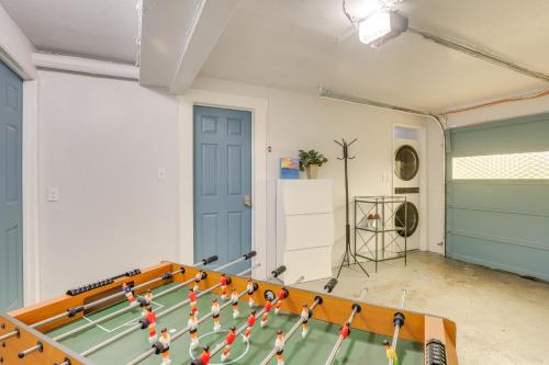 a ping pong table in a room with a ball at 7 Mi to Dtwn Pet-Friendly Abode in Seattle! in Seattle