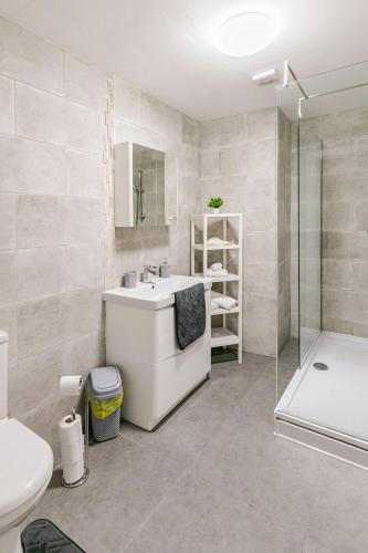 a bathroom with a sink and a toilet and a shower at New Modern and Spacious 2BR In The Heart of Burnley with Free Private Parking in Burnley