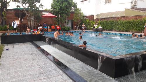 a group of people in a swimming pool at Tawan Anda Garden Hotel in Surat Thani