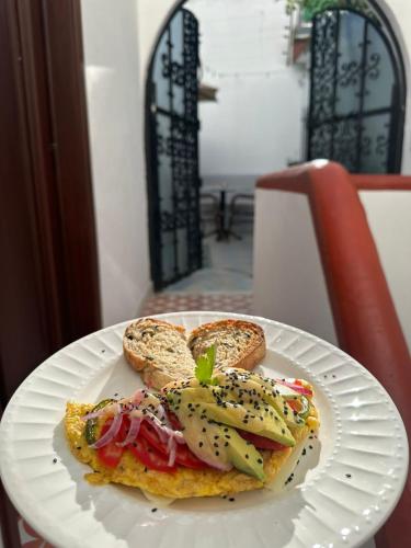 a white plate with a sandwich on a table at Nokal Exclusive Stay in Mexico City