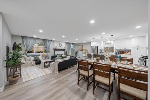 a kitchen and living room with a table and chairs at Entire Luxury 3-Bedroom House with Hot Tub, Garage, King Bed, Available Now in Spring Valley