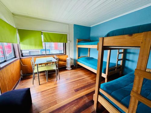 a room with two bunk beds and a table at Apart Newen Osorno in Osorno