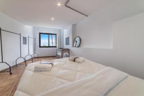 a large white bedroom with a large white bed at Chalet with sea view in Alicante in El Campello