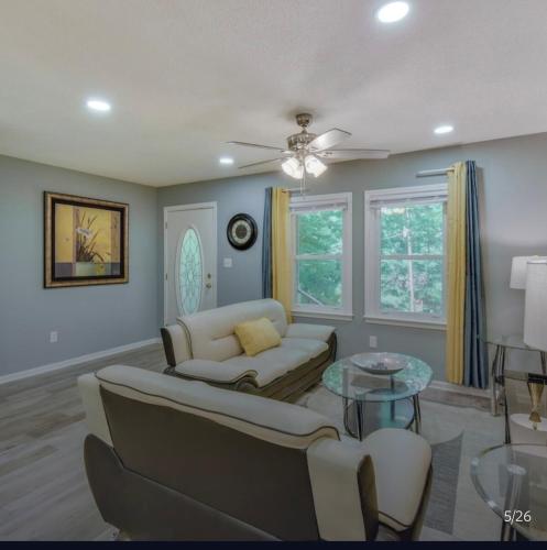 a living room with a couch and a table at Athens home with Deck Near Sanford Stadium in Athens