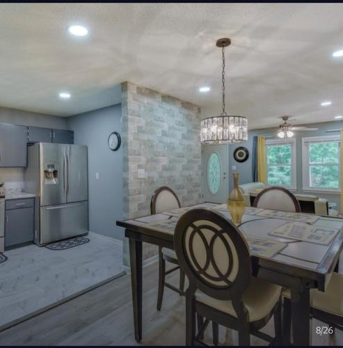a kitchen and dining room with a table and chairs at Athens home with Deck Near Sanford Stadium in Athens