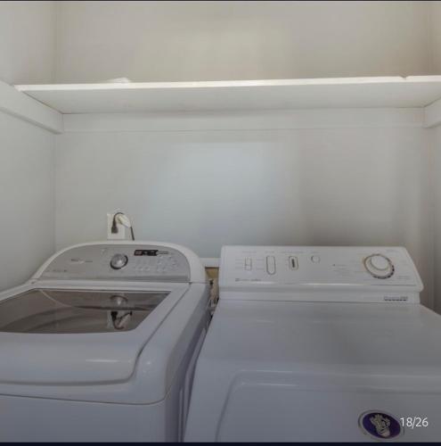a white washer and dryer in a small kitchen at Athens home with Deck Near Sanford Stadium in Athens
