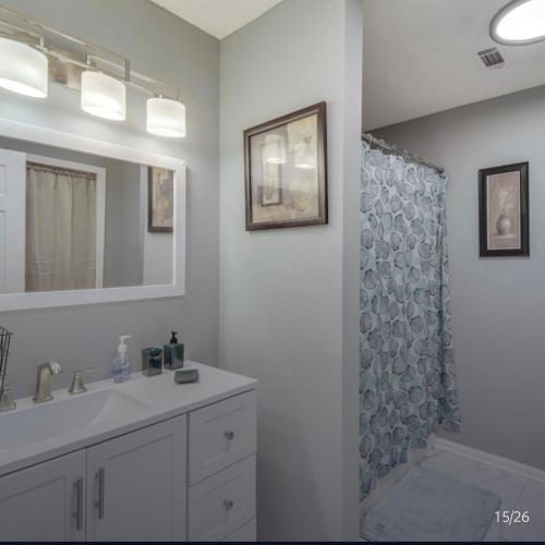 a bathroom with a sink and a shower at Athens home with Deck Near Sanford Stadium in Athens