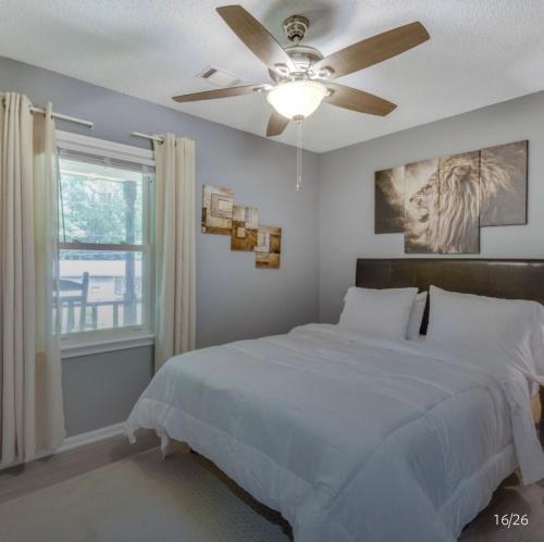 a bedroom with a bed and a ceiling fan at Athens home with Deck Near Sanford Stadium in Athens