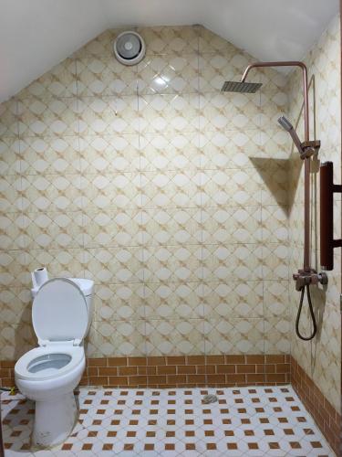 a bathroom with a toilet and a shower at Bright Michelle Homestay in Lushoto