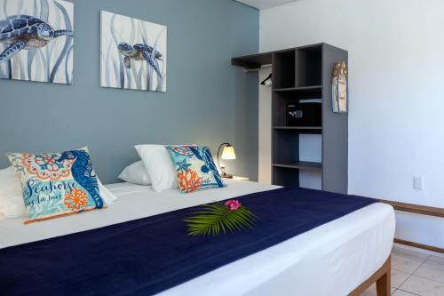 a bedroom with a large bed with blue walls at Divers Paradise - Oceanview apartment in Kralendijk