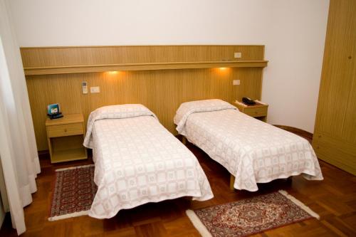 Кровать или кровати в номере Hotel Ristorante Dotto