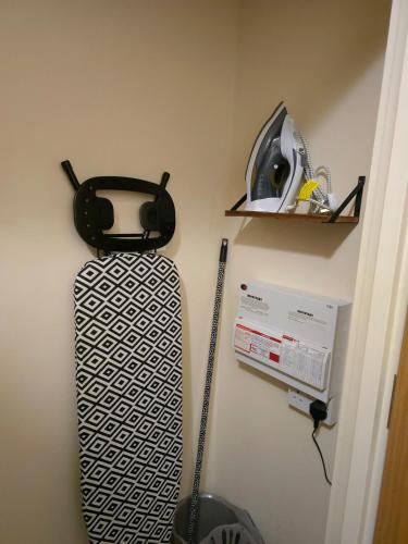 a suitcase is hanging on a wall in a room at Canalside 1 bed flat in Hertford