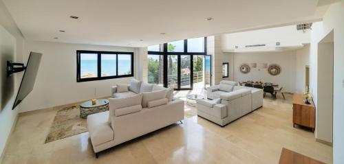 a large living room with two couches and a table at Chalet with sea view in Alicante in El Campello