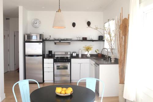 a kitchen with a table with a bowl of fruit on it at Su Casa at Venice Beach in Los Angeles