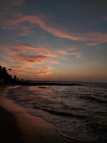 a view of the beach at sunset at Villa Manglar in Coveñas