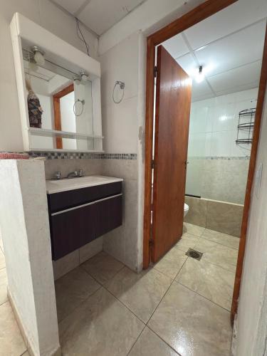 a bathroom with a sink and a mirror and a shower at Sueño de Tafi in Tafí del Valle