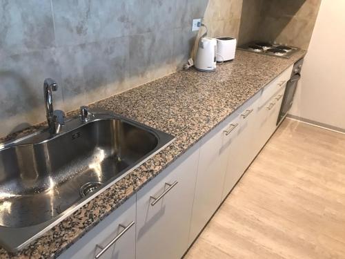 a kitchen with a sink and a counter top at Mioceno in Puerto Madryn