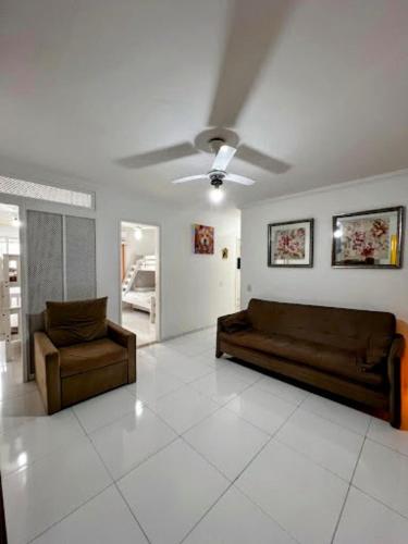 a living room with a couch and a chair at Cobertura em Caiobá-Matinhos-Pr 2 quadras do mar in Matinhos