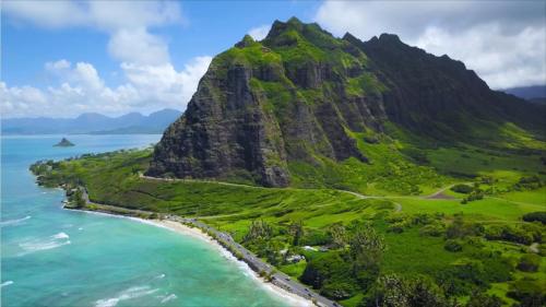 an aerial view of a mountain next to the ocean at Oceanview Condo with Loft & AC in Kaaawa