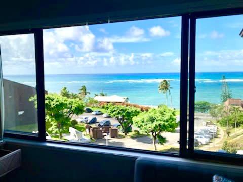 a view of the ocean from a living room window at Oceanview Condo with Loft & AC in Kaaawa
