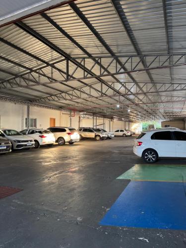 a parking garage with cars parked in it at Grande Hotel in Paranavaí