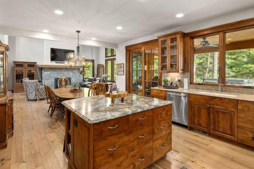 a large kitchen with wooden cabinets and a dining room at Suncadia 5 Bdrm Home Forested Hidden Gem in Cle Elum
