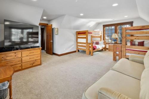 a living room with a couch and a tv and a bedroom at Suncadia 5 Bdrm Home Forested Hidden Gem in Cle Elum