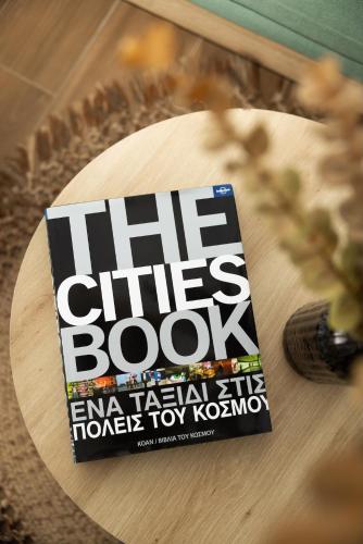 a book sitting on top of a wooden table at Flamingo Living Halkidiki - The Villas in Áyios Mámas