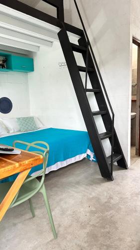 a room with a bunk bed and a staircase at A Piece of Paradise in San Carlos
