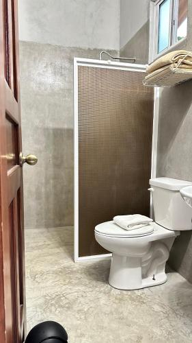 a bathroom with a toilet and a shower at A Piece of Paradise in San Carlos