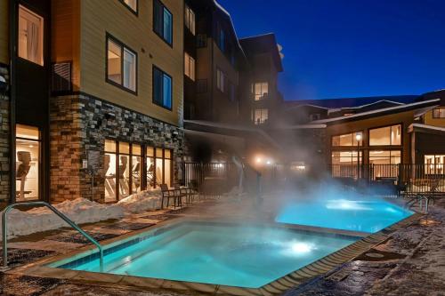 a hot tub in the courtyard of a building at night at Residence Inn Steamboat Springs in Steamboat Springs
